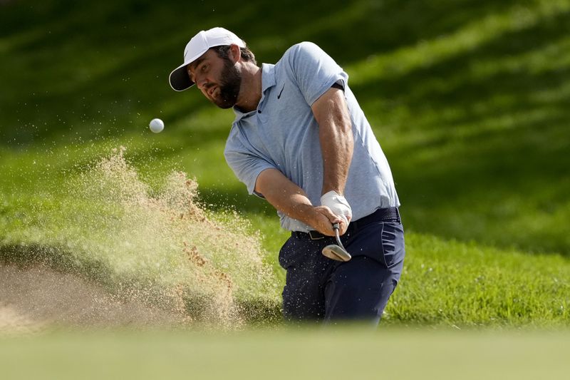 Scottie Scheffler hits from the bunker on the first hole during the first round of the BMW Championship golf event at Castle Pines Golf Club, Thursday, Aug. 22, 2024, in Castle Rock, Colo. (AP Photo/Matt York)