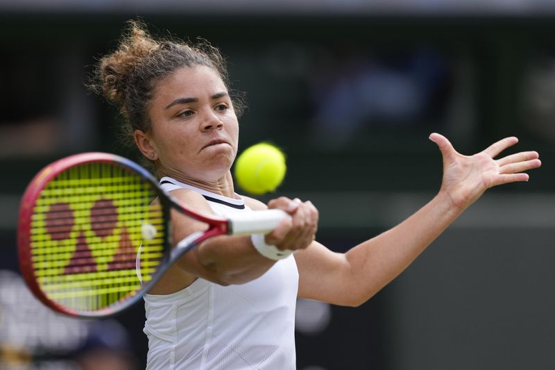 Jasmine Paolini of Italy plays a forehand return to Donna Vekic of Croatia during their semifinal match at the Wimbledon tennis championships in London, Thursday, July 11, 2024. (AP Photo/Alberto Pezzali)