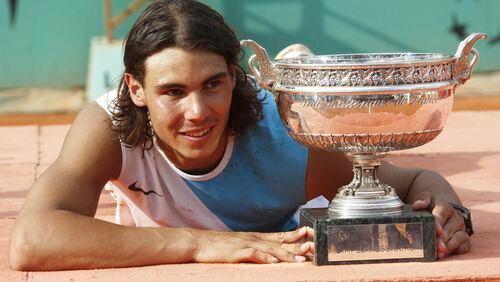 FILE - Spain's Rafael Nadal poses with the cup after defeating Switzerland's Roger Federer during the men's final match of the French Open tennis tournament at Roland Garros stadium in Paris, Sunday, June 10, 2007. Nadal won 6-3, 4-6, 6-3, 6-4. (AP Photo/Michel Spingler, File)