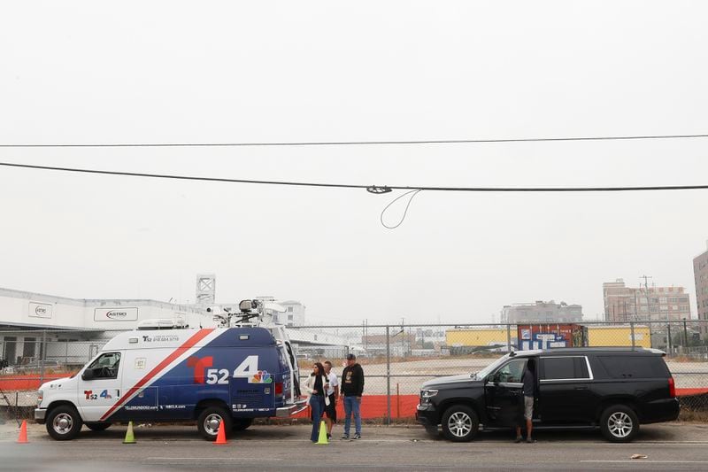 News media prepare to go live in front of a Los Angeles MTA bus depot near the site where overnight a bus was hijacked by an armed subject with passengers on board Wednesday, Sept. 25, 2024, in Los Angeles. One person was fatally shot before police apprehended the suspect. (AP Photo/Ryan Sun)