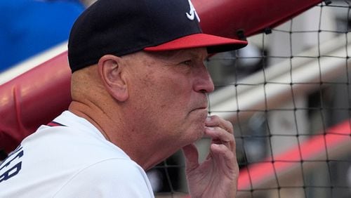 Atlanta Braves manager Brian Snitker (43) watches from the dugpout during the second inning of a baseball game against the Milwaukee Brewers, Wednesday, Aug. 7, 2024, in Atlanta. (AP Photo/John Bazemore)