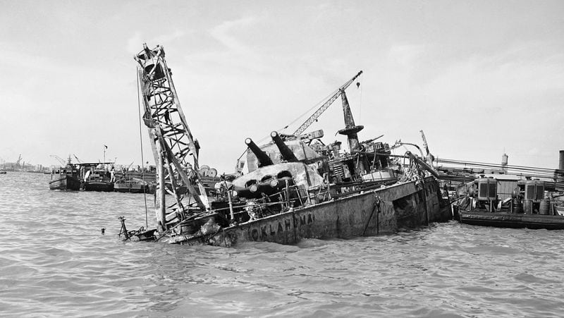 Heavy cables, straining under the terrific load, slowly right the USS Oklahoma from the bed of Pearl Harbor, Hawaii, on May 24, 1943. The American battleship sank during the Dec. 7, 1941, Japanese attack on Pearl Harbor, which started World War II.