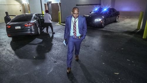 Atlanta police Lt. Germain Dearlove, who commands the department's homicide unit, walks away from the scene of a triple shooting Monday morning at the Berkeley Heights apartment building on Northside Drive. One man was killed and a father and son were injured, according to police.