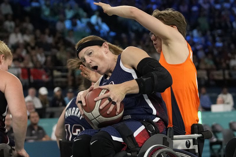 Bo Kramer of the Netherlands (right) and Natalie Schneider of the United States play during the gold medal game in women's wheelchair basketball between the Netherlands and the United States at the 2024 Paralympic Games in Paris, France, Sunday, Sept. 8, 2024. (AP Photo/Christophe Haenah)