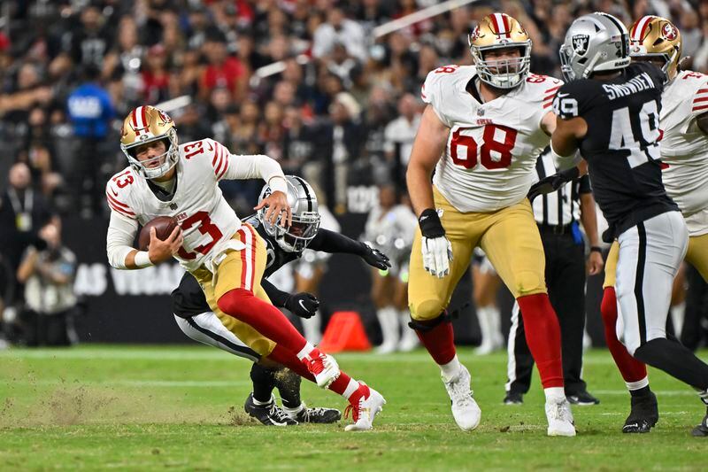 San Francisco 49ers quarterback Brock Purdy (13) runs with the ball against the Las Vegas Raiders during the first half of an NFL preseason football game, Friday, Aug. 23, 2024, in Las Vegas. (AP Photo/David Becker)