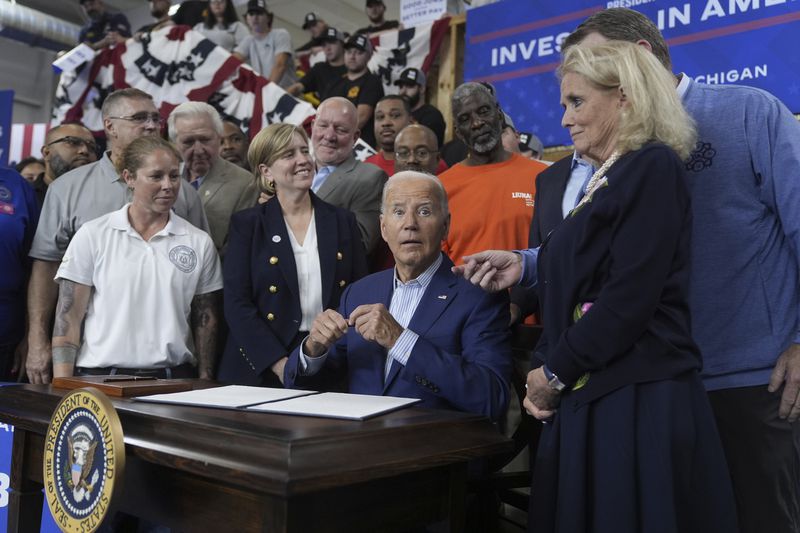 President Joe Biden speaks with Rep. Debbie Dingell, D-Mich., at a signing ceremony after speaking to labor union members about his Investing in America agenda during a visit to the U.A. Local 190 Training Center in Ann Arbor, Mich., Friday, Sep. 6, 2024. (AP Photo/Manuel Balce Ceneta)