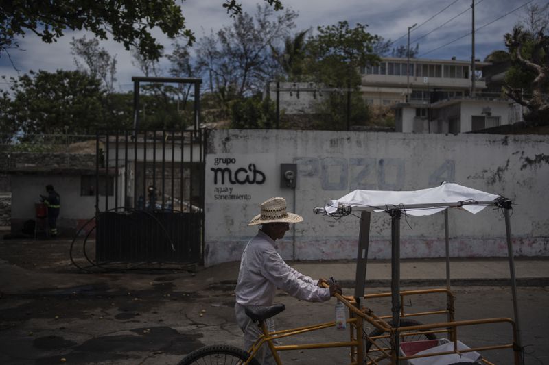 A resident drives a cart amid high temperatures in Veracruz, Mexico, Sunday, June 16, 2024. Victims in Veracruz have made up nearly a third of Mexico's heat-related deaths as temperatures have reached 100 degrees in the humid Mexican gulf state. (AP Photo/Felix Marquez)