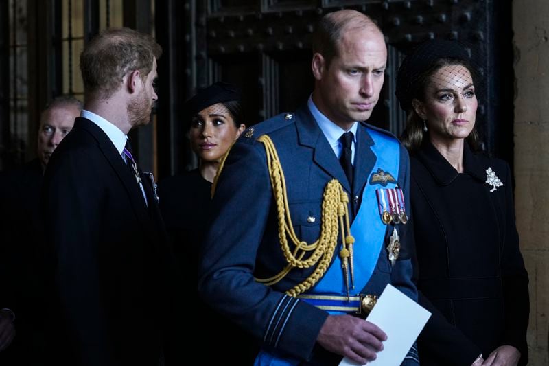 FILE - Britain's Prince William, second right, Kate, Princess of Wales, right, Prince Harry, left, and Meghan, Duchess of Sussex, second left, leave after they paid their respects to Queen Elizabeth II in Westminster Hall for the Lying-in State, in London, Wednesday, Sept. 14, 2022. (AP Photo/Emilio Morenatti, File)