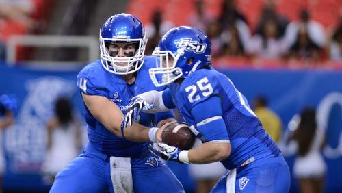 Quarterback Nick Arbuckle hands off to Kyler Neal on Saturday, Sept. 6, 2014.