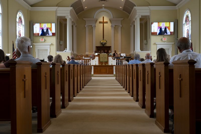 The Rev. Dr. Geoff Murphy, senior pastor at Winder First United Methodist Church, who was out of town, delivers a video message to his congregation about the Apalachee High School shootings during service Sunday, Sept. 8, 2024. Ben Gray for the Atlanta Journal-Constitution