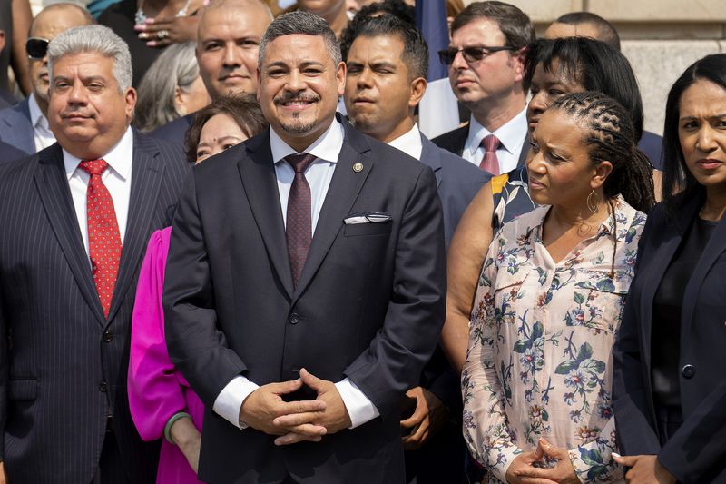 FILE - NYPD Police Commissioner Edward A. Caban, center, and First Deputy Mayor Sheena Wright, second from right, attend a press conference outside New York City Police Department 40th Precinct on Monday, July 17, 2023, in New York. (AP Photo/Jeenah Moon, File)