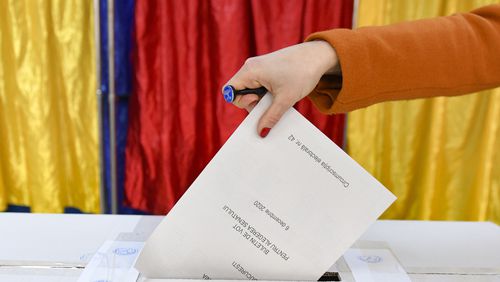 FILE - A woman casts her vote in Romania's legislative election, in Bucharest, Romania, Dec. 6, 2020. (AP Photo/Andreea Alexandru, File)