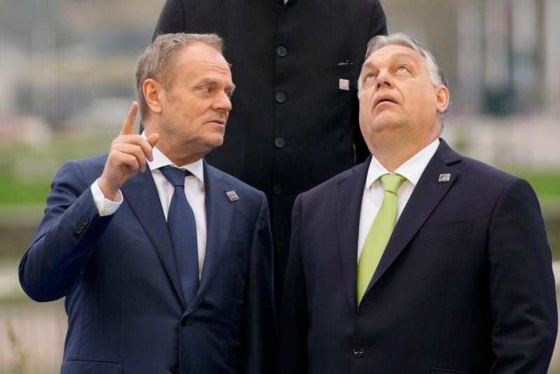 FILE - Hungary's Prime Minister Viktor Orban, right, speaks with Poland's Prime Minister Donald Tusk as they pose for a group photo during an Nuclear Energy Summit at the Expo in Brussels, on March 21, 2024. (AP Photo/Virginia Mayo, File)