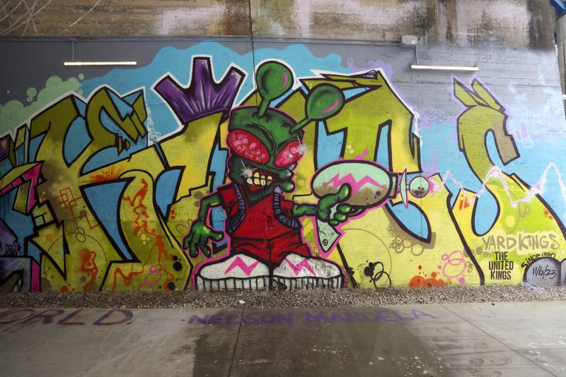 Recent work of the graffiti crew, the United Kings, is shown on the Beltline’s West Trail under the Lee Street tunnel. (Jason Getz / jason.getz@ajc.com)