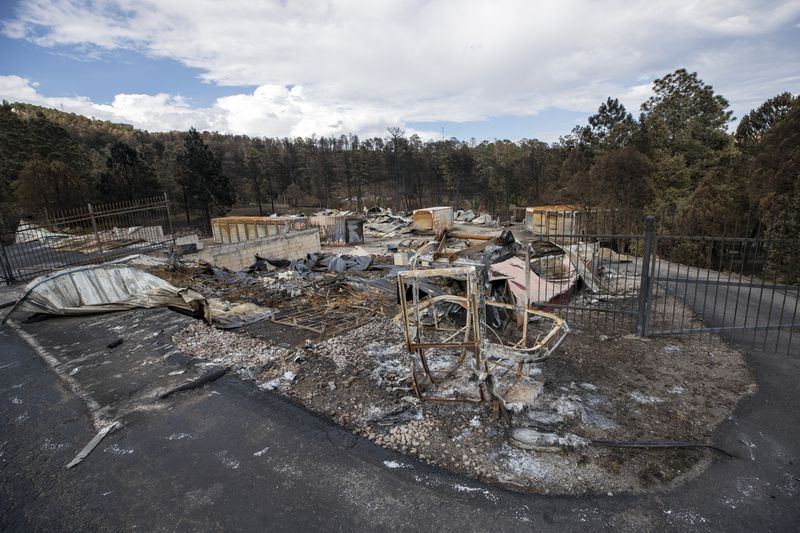 The remains of the Wild West Ski Shop, destroyed by the South Fork Fire, are pictured in the mountain village of Ruidoso, N.M., Saturday, June 22, 2024. (AP Photo/Andres Leighton)