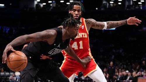 Brooklyn Nets' Dorian Finney-Smith, left, drives past Atlanta Hawks' Saddiq Bey (41) during the second half of an NBA basketball game Thursday, Feb. 29, 2024, in New York. (AP Photo/Frank Franklin II)