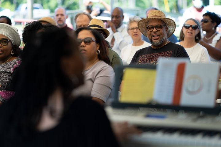 People sing during a Juneteenth celebration  at the Pierce Chapel African Cemetery in Midland, outside of Columbus, on Monday, June 20, 2022. The cemetery was rediscovered in 2019 and work has since been done to clean, document and preserve it. Ben Gray for the Atlanta Journal-Constitution