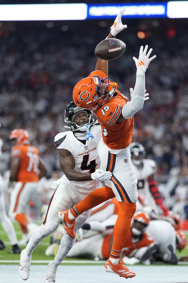 Chicago Bears wide receiver Rome Odunze (15) misses a pass in the end zone as Houston Texans cornerback Kamari Lassiter (4) defends during the first half of an NFL football game Sunday, Sept. 15, 2024, in Houston. (AP Photo/Eric Gay)