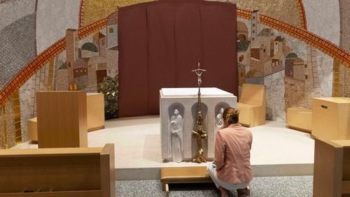 The Rev. Marko Rupnik’s mosaics depicting biblical scenes, saints and the Virgin Mary that grace the walls of Luminous Mysteries Chapel are seen covered with paper at Saint John Paul II National Shrine, Tuesday, July 23, 2024, in Washington. The Knights of Columbus, the world's largest Catholic fraternal group, has covered up defining features of the mosaics in its Washington D.C. shrine after the famous ex-Jesuit artist who designed them was accused of abusing women. The influential charitable organization announced earlier this month that it was covering the works as a sign of solidarity with victims of abuse. ( AP Photo/Jose Luis Magana)