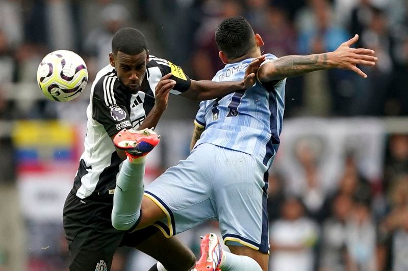 Newcastle United's Alexander Isak, left, and Tottenham Hotspur's Cristian Romero battle for the ball during the Englidh Premier League soccer match between Newcastle United and Tottenham Hotspur at St James' Park, Newcastle, England, Sunday Sept. 1, 2024. (Owen Humphreys/PA via AP)