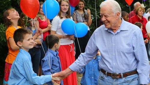 Jimmy Carter shakes hands with members of the crowd at his surprise 90th birthday party in Plains in 2014. (Curtis Compton/The Atlanta Journal-Constitution)