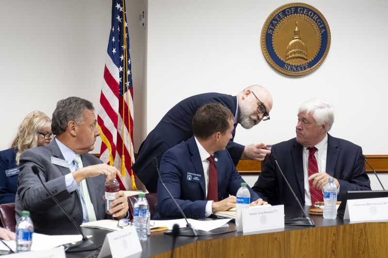 Deputy Legislative Council Stuart Morelli talks with Sen. Bill Cowsert (R-Athens), chairman of the Senate Select Committee on Investigations, before testifying to the committee Friday, Sept. 13, 2024, at the State Capitol.   Ben Gray for the Atlanta Journal-Constitution