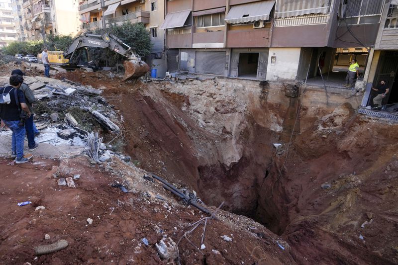 A hole in the ground near the site of the assassination of Hezbollah leader Hassan Nasrallah in Beirut's southern suburbs, Sunday, Sept. 29, 2024. (AP Photo/Hassan Ammar)