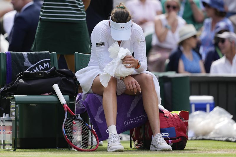 Donna Vekic of Croatia plays places a bag of ice on her wrist during a break in her semifinal against Jasmine Paolini of Italy at the Wimbledon tennis championships in London, Thursday, July 11, 2024. (AP Photo/Alberto Pezzali)