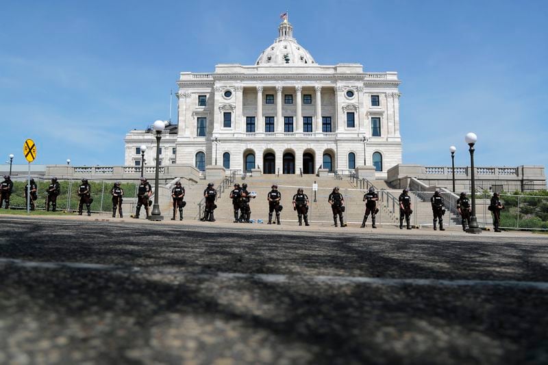 FILE - National Guard and state police guard the Minnesota statehouse Sunday, May 31, 2020, in St. Paul, Minn., following the death of George Floyd, who died after being restrained by Minneapolis police officers on May 25. (AP Photo/Julio Cortez, File)