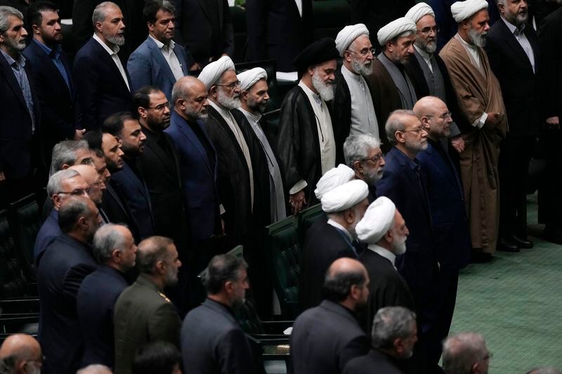 Iranian officials listen to the country's national anthem during the opening ceremony of a new parliament term, in Tehran, Iran, Monday, May 27, 2024. Monday marked the first day for Iran's newly elected parliament, following a March election that saw the country's lowest turnout since its 1979 Islamic Revolution. Of those elected to the 290-seat body, hard-liners hold over 230 seats, according to an Associated Press survey. (AP Photo/Vahid Salemi)