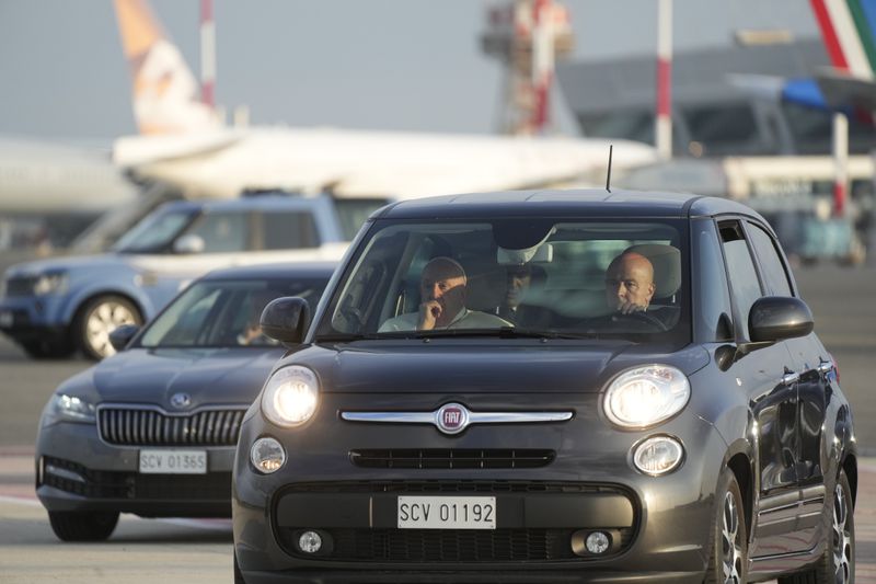 Pope Francis, left, arrives in a car at Fiumicino International airport Leonardo da Vinci, some 30 kilometers south-west of Rome, Thursday, Sept. 26, 2024 to board the papal flight to Luxembourg for a four-day visit to Luxembourg and Belgium. (AP Photo/Gregorio Borgia)