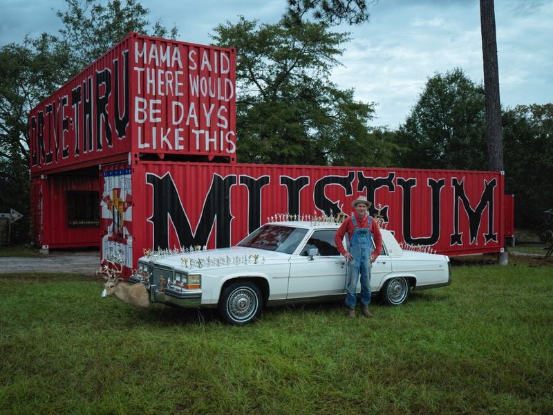 "Butch Anthony stands next to his decked-out white Cadillac at his one-of-kind drive-thru museum in rural Seale, Alabama." 
Courtesy of Steve Plattner