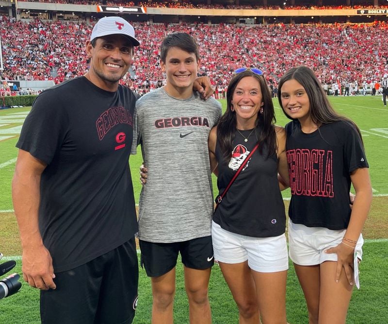 Georgia Bulldogs great and College Football Hall of Famer David Pollack stands with his family on the sidelines of Sanford Stadium for a recent Bulldogs game. (Courtesy Pollack family from UGA Athletics)