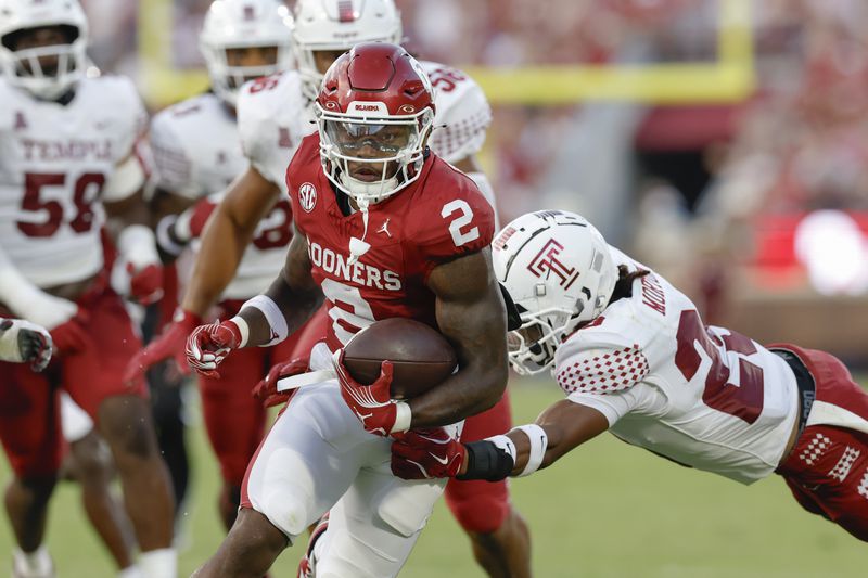 Oklahoma running back Jovantae Barnes (2) escapes a tackle for a first down against Temple during the second quarter of an NCAA college football game Friday, Aug. 30, 2024, in Norman, Okla. (AP Photo/Alonzo Adams)