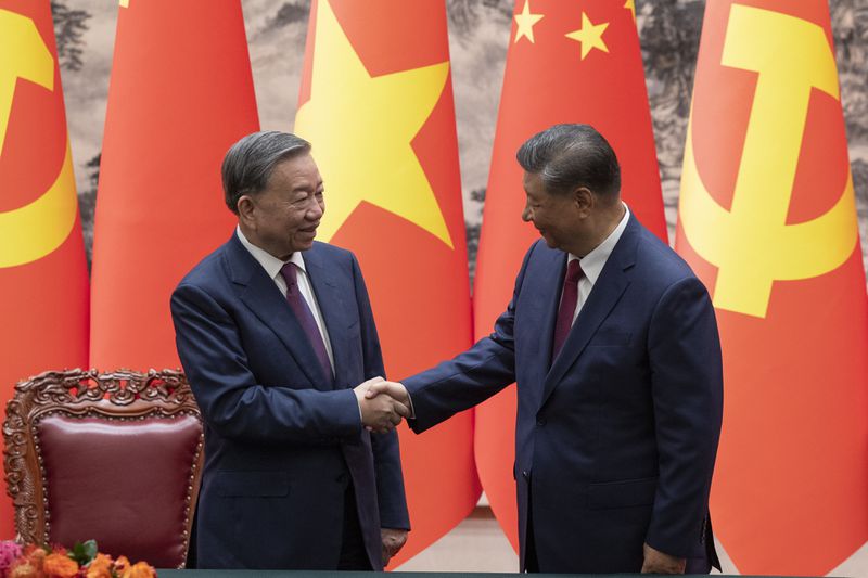 Chinese President Xi Jinping, right, and Vietnam's President To Lam shake hands after a signing ceremony at the Great Hall of the People in Beijing Monday, Aug. 19, 2024. (Andres Martinez Casares/Pool Photo via AP)