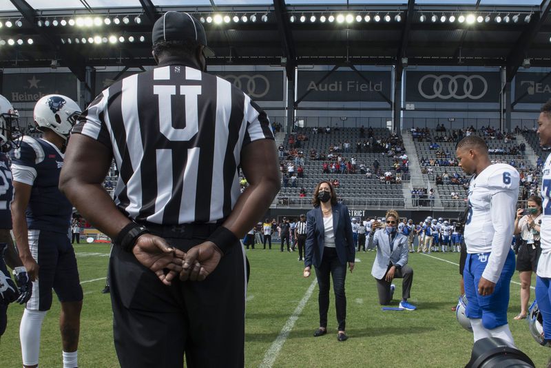 Vice President Kamala Harris takes part in the ceremonial coin toss before an NCAA college football game between Howard and Hampton in Washington, Sept. 18, 2021. (AP Photo/Cliff Owen, File)