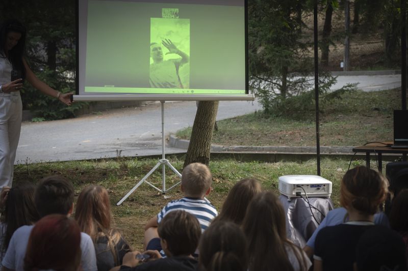 Children attend a Zoom-conference with Oleksandr Usyk, absolute world's heavyweight boxing champion, in the rehabilitation camp for children affected by war, organized by the Voices of Children charity foundation and financially supported by the Olena Zelenska Foundation in Uzhhorod, Ukraine, Tuesday, Aug. 27, 2024. (AP Photo/Efrem Lukatsky)