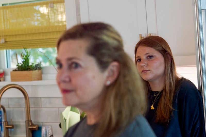 Alexia Collart, left, and her daughter Gwyneth, right, talk about her son, Marine Corporal Spencer R. Collart, in their home, in Arlington, Va., Thursday, June 19, 2024. Collart, 21, was killed along with two other Marines when the MV-22B Osprey aircraft they were on crashed during drills on a north Australian island on August 27, 2023. (AP Photo/Rod Lamkey, Jr.)