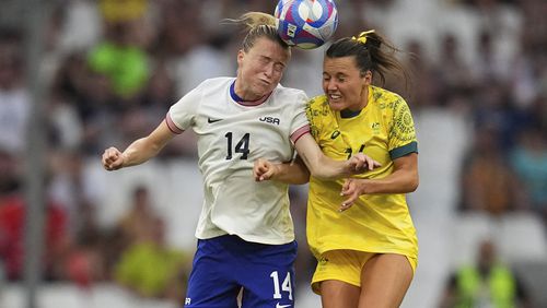 United States' Emily Sonnett, left, and Australia's Hayley Raso go for an header during a women's Group B soccer match between Australia and the United States, at the Marseille Stadium, at the 2024 Summer Olympics, Wednesday, July 31, 2024, in Marseille, France. (AP Photo/Daniel Cole)
