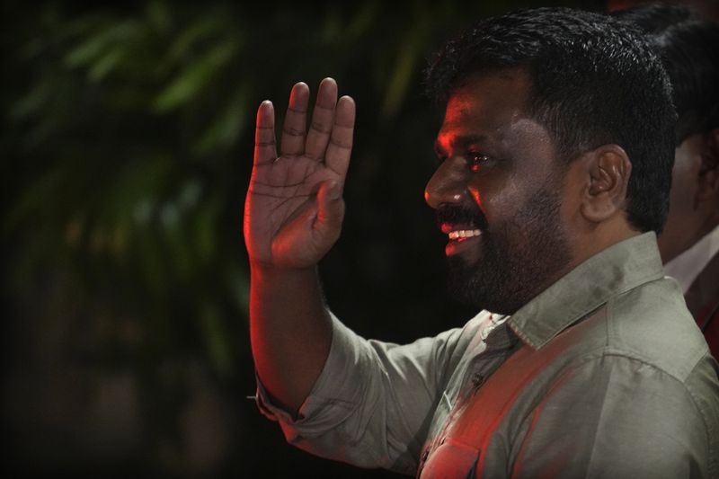 Marxist lawmaker Anura Kumara Dissanayake waves as he leaves from the election commission office after winning Sri Lankan presidential election, in Colombo, Sri Lanka, Sunday, Sept. 22, 2024. (AP Photo/Rajesh Kumar Singh)