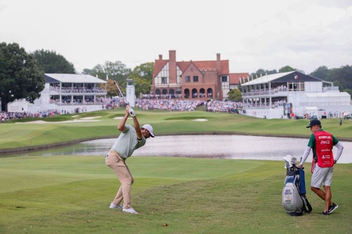 Scottie Scheffler hits his second shot on the 18th fairway during the final round of the Tour Championship at East Lake Golf Club on Sunday, Sept. 1, 2024, in Atlanta.
(Miguel Martinez / AJC)