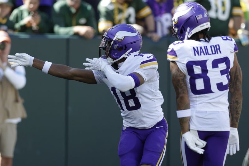 Minnesota Vikings wide receiver Justin Jefferson (18) celebrates a touchdown during the first half of an NFL football game against the Green Bay Packers, Sunday, Sept. 29, 2024, in Green Bay, Wis. (AP Photo/Matt Ludtke)