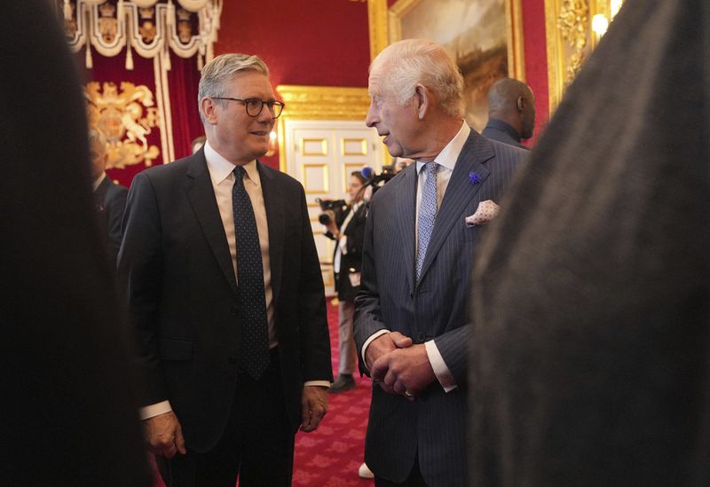 King Charles III with Prime Minister Sir Keir Starmer at an event for The King's Trust to discuss youth opportunity, at St James's Palace in central London, Friday July 12, 2024. The King and Mr Elba, an alumnus of The King's Trust (formerly known as The Prince's Trust), are meeting about the charity's ongoing work to support young people, and creating positive opportunities and initiatives which might help address youth violence in the UK, as well as the collaboration in Sierra Leone between the Prince's Trust International and the Elba Hope Foundation. (Yui Mok/pool photo via AP)