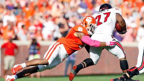 Vic Beasley #3 of the Clemson Tigers makes a tackle on L.J. Scott #27 of the Louisville Cardinals during the game at Memorial Stadium on October 11, 2014 in Clemson, South Carolina. (October 10, 2014 - Source: Tyler Smith/Getty Images North America)