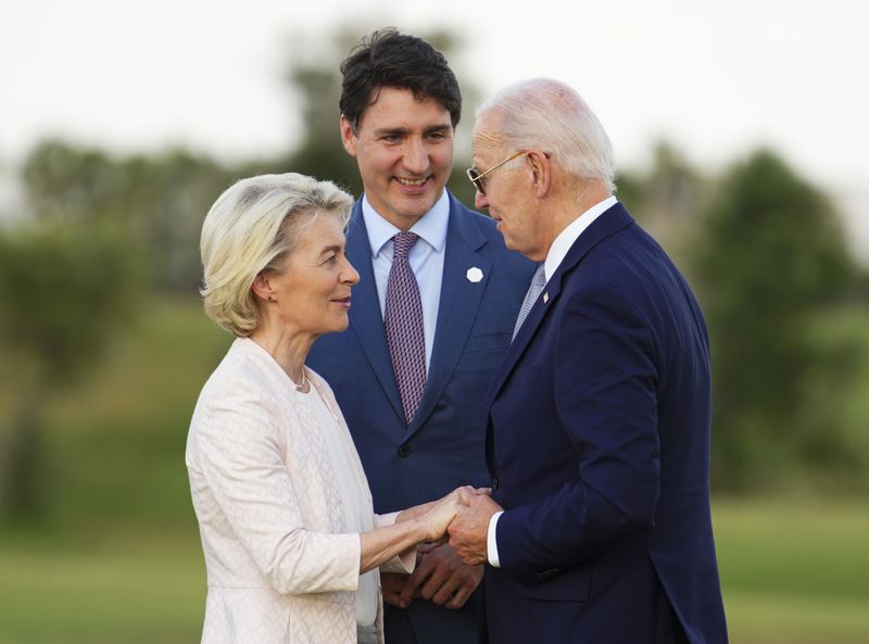 Canadian Prime Minister Justin Trudeau, middle, President of the European Commission Ursula von der Leyen, left, and U.S. President Joe Biden talk as they wait for the start of a skydiving exhibition during the G7 Summit in Savelletri di Fasano, Italy on Thursday, June 13, 2024. (Sean Kilpatrick/The Canadian Press via AP)
