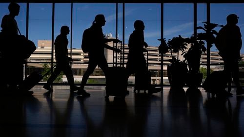 Travelers walk through the Philadelphia International Airport, Wednesday, July 3, 2024, in Philadelphia. (AP Photo/Matt Slocum)