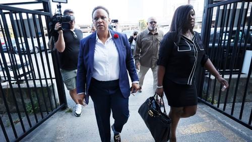 Pastor Mitzi Bickers, left, crosses the parking lot gates toward the U.S. District Court from the underground entrance in Atlanta on Thursday, September 8, 2022. The former Atlanta City Hall official was convicted earlier this year of conspiracy to commit bribery and eight other counts related to a cash-for-contracts scheme. Thursday, September 8, 2022. Miguel Martinez / miguel.martinezjimenez@ajc.com