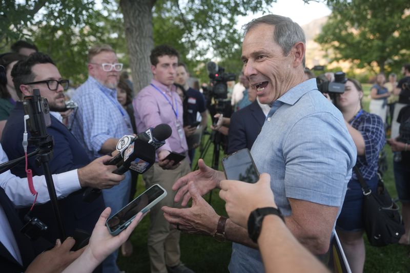 U.S. Rep. John Curtis speaks with reporters after his win during an election night party, Tuesday, June 25, 2024, in Provo, Utah. Curtis has won the Utah GOP primary for Mitt Romney's open U.S. Senate seat, defeating one opponent who was endorsed by former President Donald Trump and others who said they supported Trump's agenda. (AP Photo/Rick Bowmer)