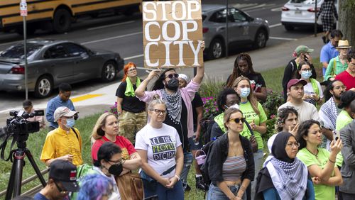 Opponents of an under-construction law enforcement training center that critics call "Cop City," protest at City Hall in Atlanta, Monday, Sept. 16, 2024. (Arvin Temkar/Atlanta Journal-Constitution via AP)