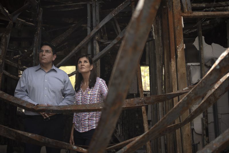 FILE - Danny Danon, a member of the Knesset, Israel's parliament, left, and Nikki Haley, former U.S. Ambassador to the United Nations, visit a home torched by Hamas in Kibbutz Nir Oz in southern Israel, Monday, May 27, 2024. A new kind of tourism has emerged in Israel in the months since Hamas’ Oct. 7 attack. For celebrities, politicians, influencers and others, no trip is complete without a somber visit to the devastated south that absorbed the brunt of the assault near the border with Gaza. (AP Photo/Maya Alleruzzo, File)